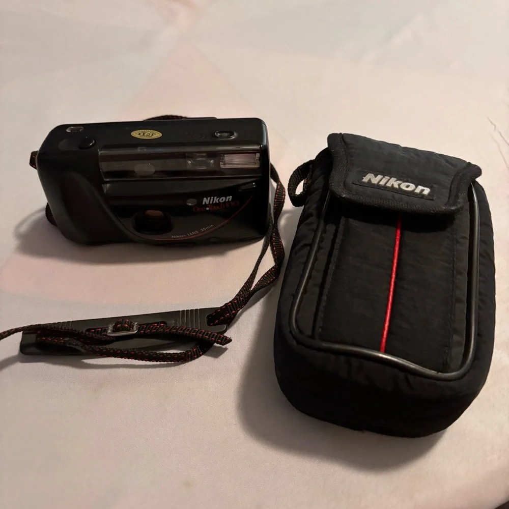 Nikon Black Camera with Red Accents and Case don’t know if it works